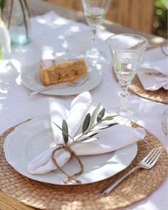 the table is set with plates, napkins and utensils for two people