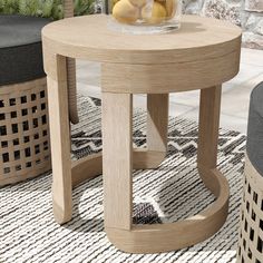 a wooden table sitting on top of a rug next to a vase filled with fruit