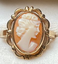 Vintage 10K yellow gold cameo ring for your consideration. The star of the show is the cameo.  It is set in a decorative bezel setting right with a right facing lady.  The scalloped frame provides detail and interest.  The setting 18mm tall and 14.5mm wide.  The band measures 1.9mm in the back.  It is a size 6 1/2 and weighs 3.72 grams. It is a truly beautiful ring! Cameo 14k Gold Rings For Collectors, Collectible 14k Gold Cameo Rings, 14k Gold Cameo Rings For Collectors, Scalloped Frame, Sweet Jewelry, Mom Ring, Cameo Ring, Butterfly Ring, Ring Fit