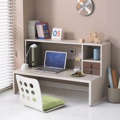 a computer desk with a laptop on top of it