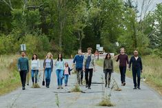 a group of people walking down a road