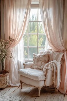 a white chair sitting in front of a window with curtains on the windowsills