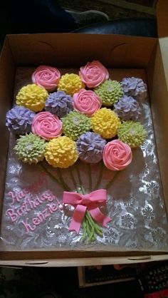 a birthday cake in a box decorated with flowers