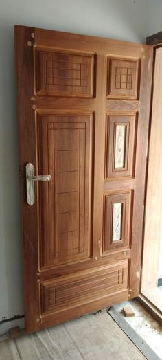 a wooden door with glass inserts on the front and side doors are being installed