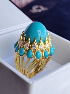 Glorious Vintage Turquoise & Diamond Ring 925 Sterling Silver, Cluster Ring, Antique Turquoise Ring, Victorian Turquoise Dome Ring, All Size, Yellow Gold Plated Ring 💍 Product Specification 💍 💍 𝐌𝐄𝐓𝐀𝐋 💍 ➡ Type : Ring ➡ Band Color : Yellow ➡ Base Metal : Solid 925 Sterling Silver ➡ Plating: 14K Yellow Gold Plated 💍 𝐌𝐀𝐈𝐍 𝐒𝐓𝐎𝐍𝐄 💍 ➡ Stone Type : Turquoise ➡ Stone Creation : Lab Created  ➡ Grade: We use AAAAA quality stones which gives even better radiance than real diamonds & gems Luxury Turquoise Cabochon Ring, Luxury Turquoise Ring Jewelry, Luxury Turquoise Round Ring, Luxury Blue Teardrop Rings, Hallmarked Turquoise Ring Fine Jewelry, Hallmarked Turquoise Fine Jewelry Ring, Luxury Turquoise Ring As A Gift, Luxury Turquoise Ring Gift, Turquoise Rings With Gemstone Accents In Fine Jewelry Style