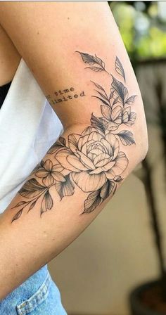 a woman with a flower tattoo on her arm