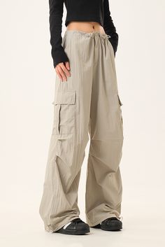 Functional Style With A Relaxed Fit These adjustable drawstring parachute cargo pants offer a lightweight, breathable, and durable construction, ensuring maximum comfort during wear. The unique parachute design blends a loose fit with versatile drawstring details, enhancing both the functionality and style of the pants. The drawstring cuffs allow you to customize the fit, creating different silhouettes to suit your style. Style #: WWAJ048 Parachute Design, Parachute Cargo Pants, Loungewear Summer, Parachute Cargo, Tank Top Skirt, Casual Activewear, Functional Style, Silk Knit, Fall Coat