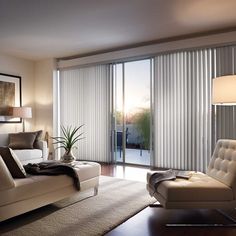 a living room filled with furniture and a sliding glass door