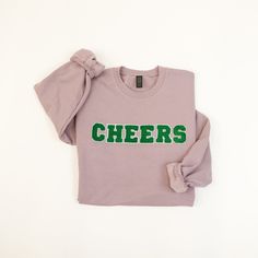 Your new brunch bff, our CHEERS sweatshirt is a fun weekend option to add to your closet! This lavender sweatshirt with kelly green varsity letters feels as soft and cozy as it looks. Unisex fit 80% cotton, 20% polyester Sizes S-XL available Fits true to size, size up for an oversized look Varsity Letter Sweatshirt, Lavender Sweatshirt, Varsity Letters, Letter Sweatshirt, Varsity Letter, Sweatshirt Designs, Kelly Green, Lavender, Graphic Tees