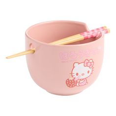 a hello kitty cup with two chopsticks in it