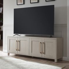 a flat screen tv sitting on top of a wooden cabinet