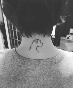 a black and white photo of a woman's neck with a dog tattoo on it