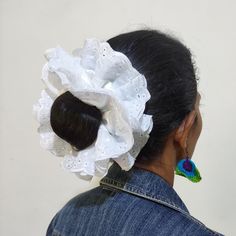 the back of a woman's head wearing a white scrunffle hair piece