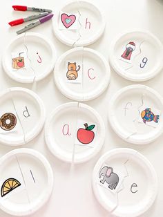 paper plates with matching letters and numbers on them are arranged in the shape of an apple