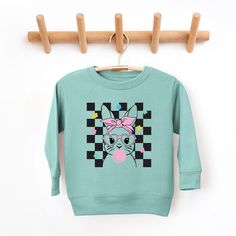 Looking for a cute sweatshirt for your kids? We have the perfect Checkered Groovy Bunny graphic sweatshirt addition to their closet! Also available in youth sweatshirts. Playful Long Sleeve Sweatshirt With Character Print, Cute Long Sleeve Sweatshirt With Character Print, Playful Long Sleeve Graphic Sweater, Playful Crew Neck Sweatshirt With Character Print, Fun Cotton Sweater With Graphic Print, Fun Long Sleeve Sweatshirt With Character Print, Fun Cartoon Print Sweatshirt, Playful Cotton Sweatshirt With Graphic Print, Playful Long Sleeve Sweatshirt With Cartoon Print