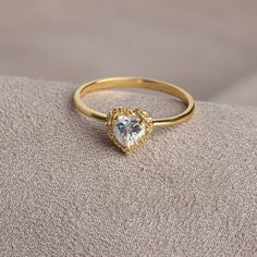 Our 14K Solid Gold heart-cut white topaz ring surrounded by real diamonds is suitable for daily use with its special design and will be your indispensable jewelry that you can use on your special days. A stylish jewel for you and your loved ones. Time to pamper yourself and your love.  White topaz is the birthstone for those born in April. 🤍🤍 Special gifts for your special moments. We produce our jewelry in the most perfect way for you. 🤍🤍 All of our products are made of 14K solid gold. FEAT Yellow Gold Heart-shaped Jewelry With Halo Setting, Yellow Gold Heart Jewelry With Halo Setting, Heart-shaped Yellow Gold Jewelry With Halo Setting, Yellow Gold Jewelry With Heart Shape Halo Setting, Elegant Pear-shaped Crystal Ring As Gift, Elegant Pear-shaped Crystal Ring For Gift, Formal Heart Ring With Prong Setting For Valentine's Day, Formal Heart Ring For Valentine's Day With Round Cut, Elegant Heart Ring For Wedding And Mother's Day