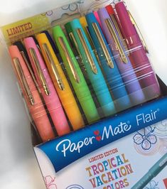 a box filled with lots of different colored pens next to a package of paper mate flasks