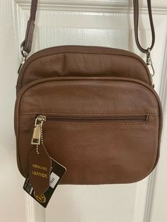 NWT - ROMA LEATHERS CONCEALED CARRY SQUARE CROSSBODY BAG with Lock & Key & HOLSTER (velcroes in pocket) & 1 Velcro Strap.  #7023 - BROWN - 100% GENUINE LEATHER - 8" x 4" x 8"  Note: the bag is a beautiful brown like the 1st photo and with beautiful brown lining. Sorry, the lighting in a few of the last photos distorted the color.   Wire Reinforced Adjustable Detachable Shoulder Strap SIX COMPARTMENTS: (1) Front has a zipper pocket. (2) Front has a 2nd Zipper Organizer Compartment with a clear ID Brown Rectangular Shoulder Bag With Anti-theft Pocket, Brown Bags With Anti-theft Pocket For On-the-go, Brown Anti-theft Pocket Bag For On-the-go, Brown Anti-theft Pouch Bag, Brown On-the-go Bag With Anti-theft Pocket, Brown On-the-go Bags With Anti-theft Pocket, Rectangular Satchel With Anti-theft Pocket For Everyday Use, Brown Shoulder Bag With Anti-theft Pocket For On-the-go, Classic Bags With Anti-theft Pocket For Everyday Use