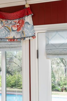 the window valances are decorated with red, white and blue fabric