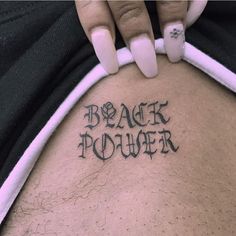 a woman's back with the words black power written on it