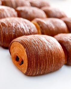 several wooden spools sitting on top of a white table next to each other