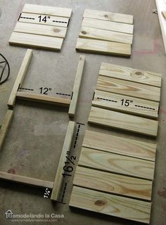 some wood pieces are laying on the floor next to measuring tape and rulers for measurements