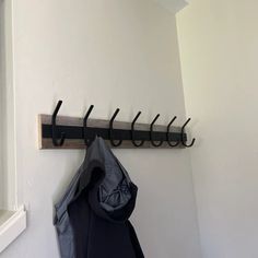 a coat rack is hanging on the wall