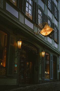 an old building with a neon sign on the front