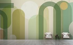 two white chairs sitting in front of a wall with green and yellow circles on it