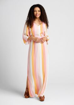 All the sweetness of summer is simply radiating from the creamy sorbet-esque hues of this ModCloth x Collectif collab striped maxi dress ! Made from a lightweight woven fabric with a vintage-inspired vertical stripe design in delicious shades of pink, white, and yellow, this beautiful floor-length dress boasts a V-neckline, elbow-length sleeves with delicate asymmetrical detailing at the cuff, and a retro-fab waistline that is sweetly cinched by a pink-hued adjustable belt. Elegant enough for a Pink Vertical Striped Summer Dress, Pink Vertical Stripe Summer Dress, Spring Dresses With Vertical Stripes In Multicolor, Spring Beach Dresses With Vertical Stripes, Striped Maxi Dress For Beach In Spring, Striped Maxi Dress For Spring Beach Occasions, White Maxi Dress With Vertical Stripes For Spring, Spring Multicolor Striped Dresses, Summer Striped Maxi Dress