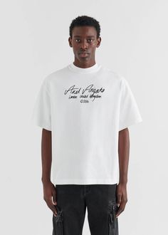 The oversized Essential T-shirt is cut from organic cotton in a classic crew-neck profile. Our seasonal handwritten logo is printed across the chest. 

The model is 188cm / 6'2 ft wears a size M.. Cocktails Drawing, Oversized Street Style, Handwritten Logo, Creative T Shirt Design, Minimalist Shirts, Merch Ideas, Axel Arigato, Tshirt Outfits, Crew Neck Shirt