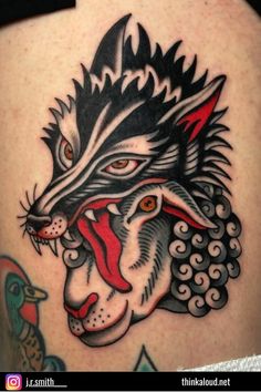 an animal tattoo on the back of a woman's thigh, with a wolf head