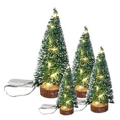 three small christmas trees with lights on them