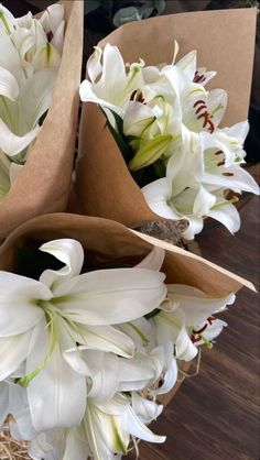 some white flowers are in a brown paper bag