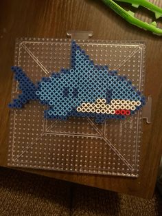 a piece of perler art made to look like a fish