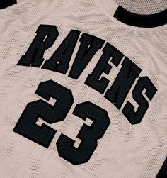 the back of a white jersey that says raven's 32 on it with black lettering