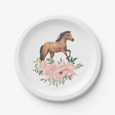 a paper plate with a horse and flowers painted on the side, in front of a white background