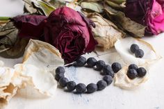 some flowers and beads on a table