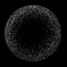 a black and white photo of an object with bubbles in the air on a dark background