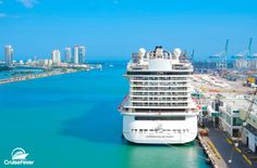 a cruise ship docked in the water next to some buildings and other large cityscapes