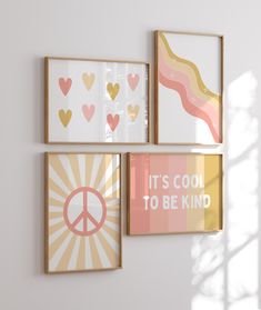 three framed art pieces hang on the wall next to each other, including one with a peace sign