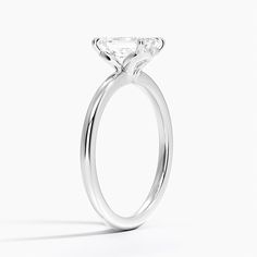 a close up view of a diamond ring on a white background with the center stone visible