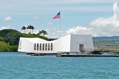 a large white building sitting on top of a body of water