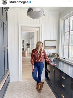 a woman standing next to a kitchen counter