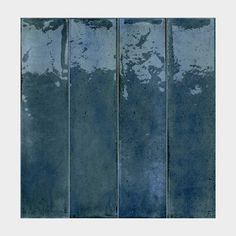 an abstract photograph of blue paint on the side of a wall with vertical lines in it