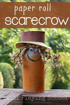 a toilet paper roll scarecrow with a hat on