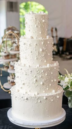 a large white wedding cake sitting on top of a table