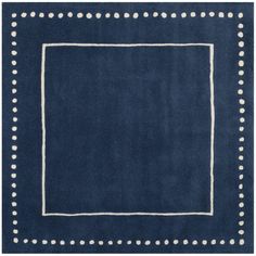 a blue rug with white polka dots on the border and a square in the middle