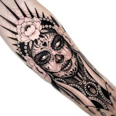 a black and white tattoo with a woman's face on the left side of her arm