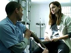 a woman sitting on top of a bed next to a man in a hospital room